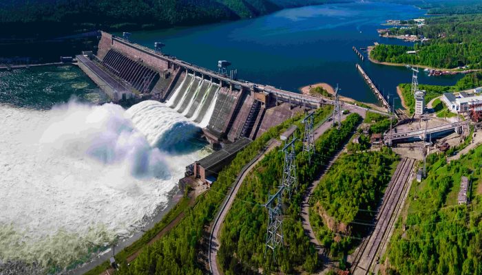 Hydroelectric dam on the river, water discharge from the reservoir, aerial photography