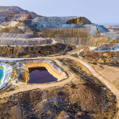 Aerial panorama of Skouriotissa copper mine in Cyprus with ore piles and multicolored pools