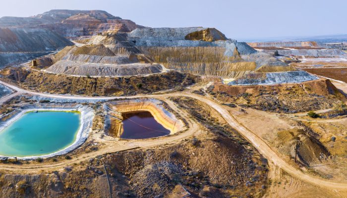 Aerial panorama of Skouriotissa copper mine in Cyprus with ore piles and multicolored pools