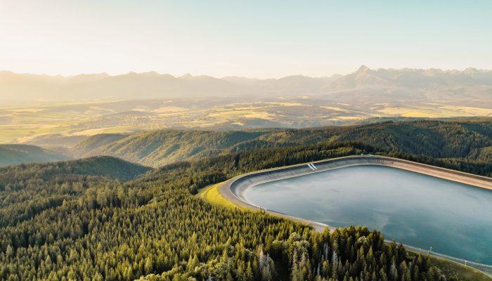 Hydroelectric power plant Cierny Vah. Sunset in Slovakia, Liptov. High Tatras scenery. Monumental peaks over water level